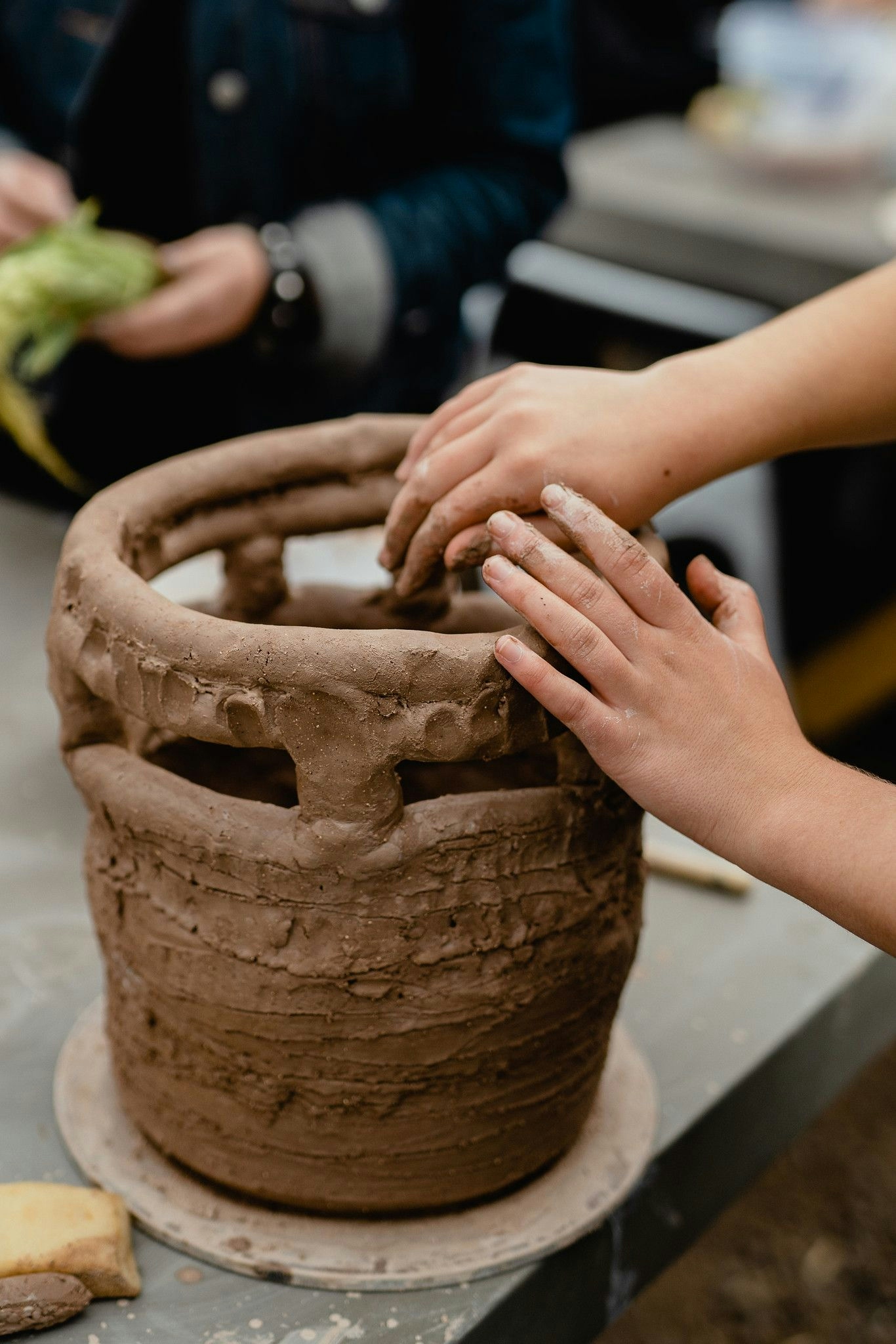 Hand on tall clay pot