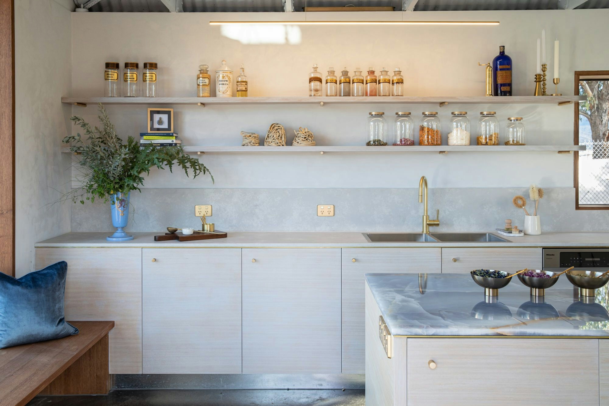 Beauty lab shelving with bottles and botanicals