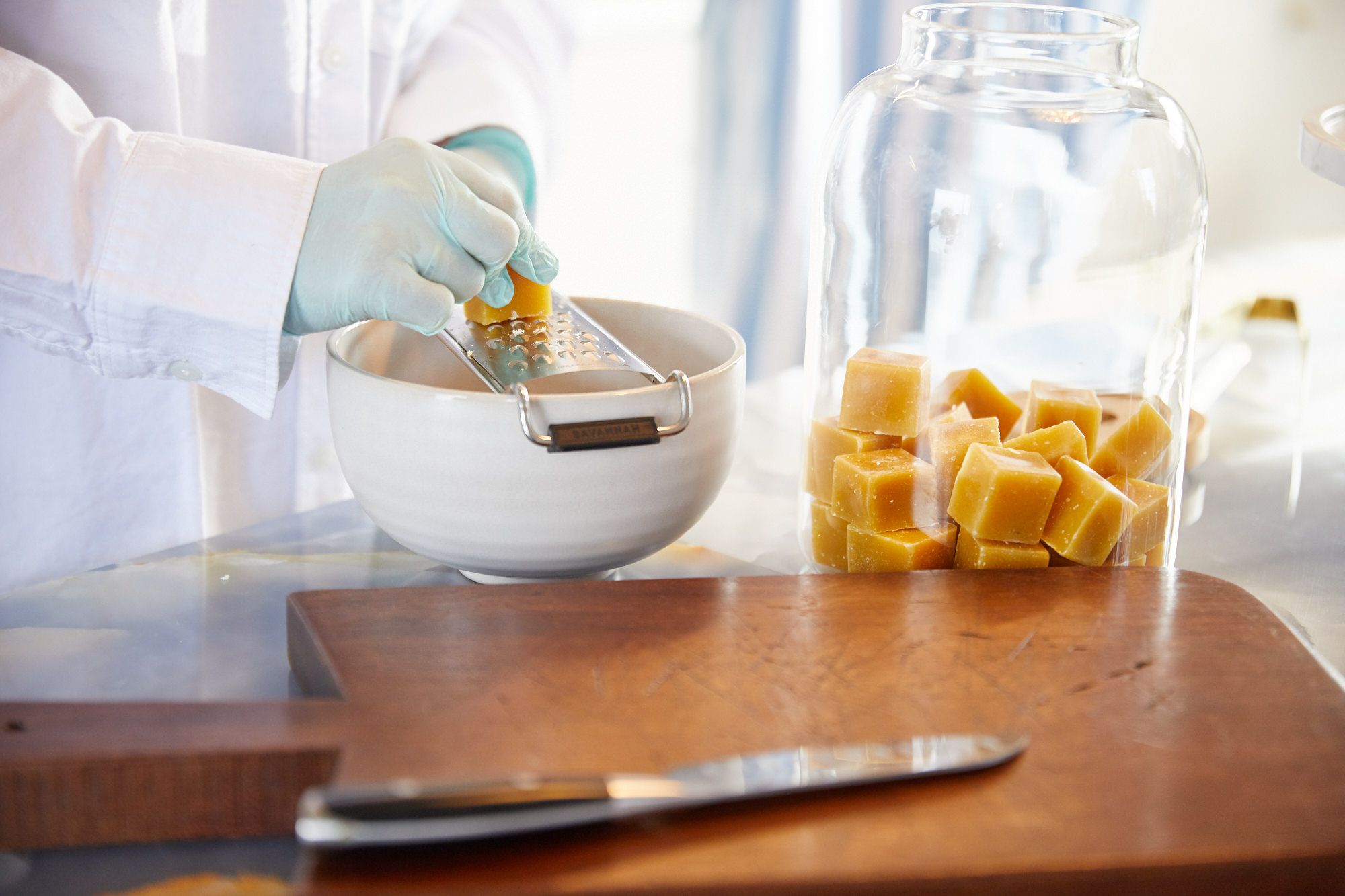 Blocks of beed wax being grated