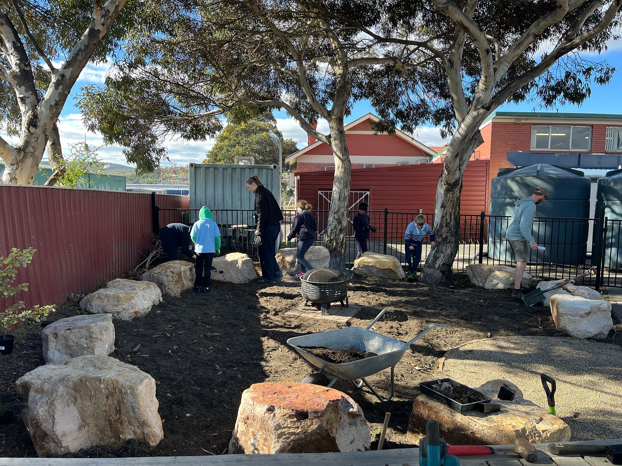 STUDENTS PLANTING IN THE GARDEN